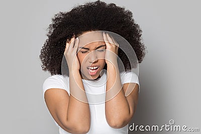 Unhappy young african american woman suffering from strong head ache. Stock Photo