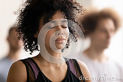 Young peaceful african american woman enjoying deep meditation. Stock Photo