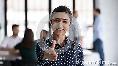 Friendly indian boss greeting client stretch out hand for handshake Stock Photo