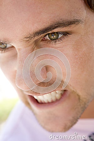 Head shot of man scowling Stock Photo