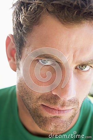 Head shot of man scowling Stock Photo