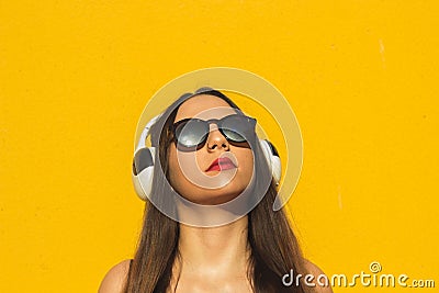 Head shot of a model listening music in headphones Stock Photo