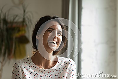 Head shot of overjoyed woman laughing at joke, having fun Stock Photo