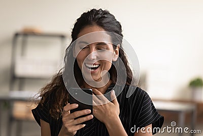Head shot overjoyed woman looking at phone screen, good news Stock Photo