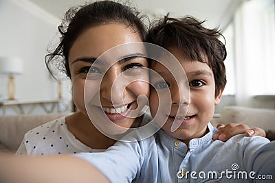 Head shot portrait Indian mother with son taking selfie together Stock Photo