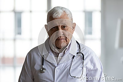 Head shot portrait older doctor wearing white uniform with stethoscope Stock Photo