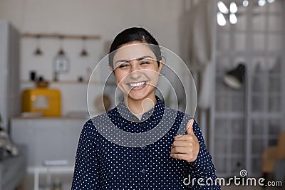 Head shot portrait overjoyed Indian woman showing thumb up Stock Photo