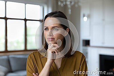 Headshot portrait pensive woman touch chin looking into distance Stock Photo