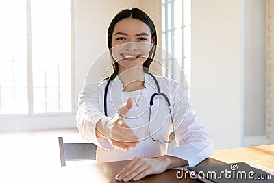 Young female general practitioner reaching out hand. Stock Photo