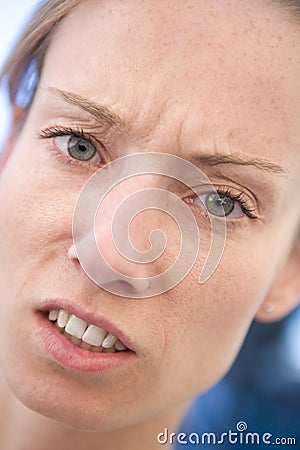 Head shot of woman scowling Stock Photo