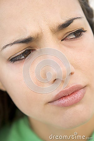 Head shot of woman scowling Stock Photo