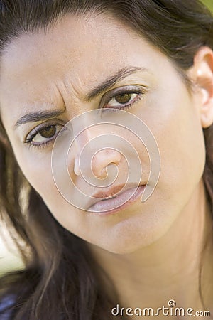 Head shot of woman scowling Stock Photo