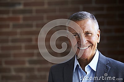 Head And Shoulders Portrait Of Mature Businessman In Office Stock Photo