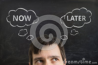 Head of young man making decision to do it now or later. Stock Photo