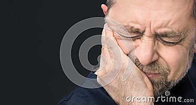 Headache. Man with face closed by hand Stock Photo