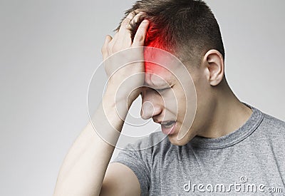 Headache Pain. Millennial man having painful migraine Stock Photo