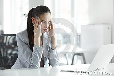 Headache and Stress at Work. Portrait of Young Business Woman at Stock Photo