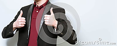 Headcropped european business man in red polo shirt and blazer showing 2 thumb ups wishing good luck. Place for text, copyspace. Stock Photo