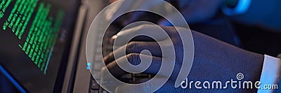 Header Image of Typing on Laptop Keyboard with Code Displayed Stock Photo