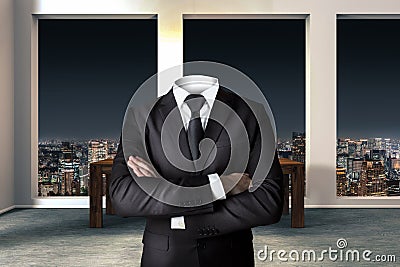 Headless businessman with crossed arms in modern urban office Stock Photo