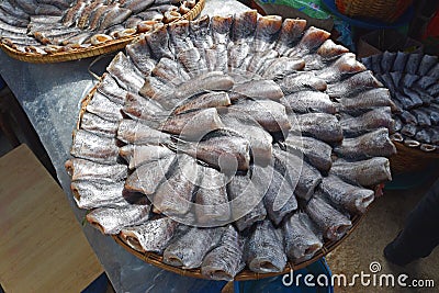 Headless dried fish called Pla Salit on round bamboo basket Stock Photo