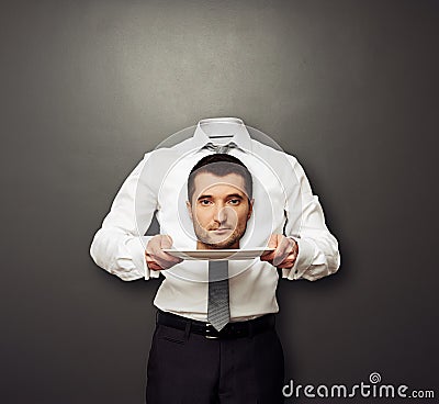 Headless man holding head on white plate Stock Photo