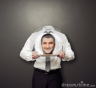 Headless man holding smiley head Stock Photo