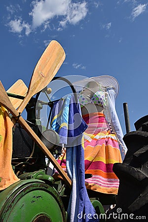 Headless mannequin perched on a tractor seat Stock Photo