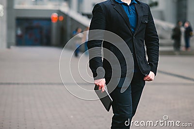 Headless portrait of a businessman holding a tablet computer on the background of the city. Stock Photo