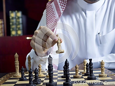 An Arab man playing chess at his desk 4 Stock Photo