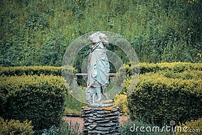 Headless statue of with a sheep in the garden Stock Photo