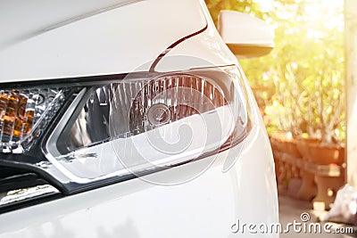 Headlight of city car with sunlight flares Stock Photo