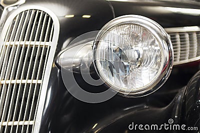Headlight lamp vintage car. Headlight lamp vintage classic car. Front part with the headlight retro car closeup Stock Photo