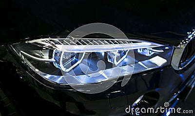 Headlight of a modern sport car. Front view of luxury sport car. Car exterior details. The front lights of the car. Stock Photo