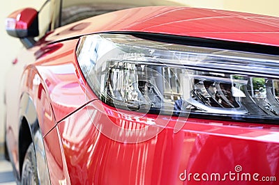 close up headlight of red car, transportation industry Stock Photo