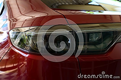 close up headlight of red car, transportation industry Stock Photo