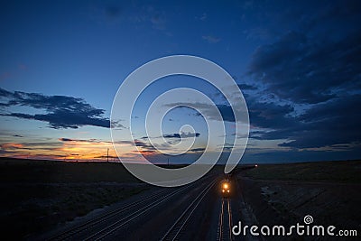 Two coal trains roll through Wyoming at sunset Stock Photo