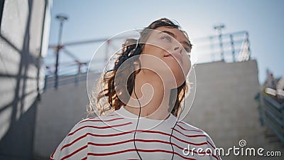 Headphone girl relaxing sunlight moving in tact song outdoors close up. Stock Photo