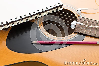 Headphone guitar notebook and pencil Stock Photo