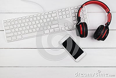 Headphone mobile phone and keyboard on wood background Stock Photo