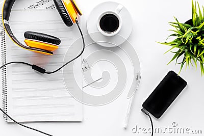 Headphone, mobile phone with white paper note in music studio for dj or musician work on white background top view mock Stock Photo