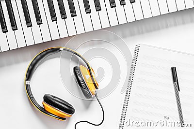 Headphone, notebook and synthesizer in music studio for dj or musician work white desk background top view mock-up Stock Photo