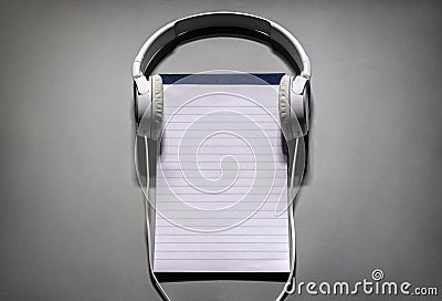 Headphones with blank notebook or notepad background with copy space for playlist or podcast Stock Photo