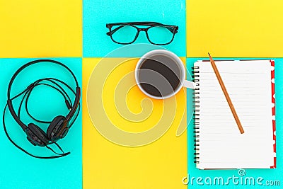 Headphones and Coffee cup a on difference colorful bright board. Music concept.Top view Stock Photo