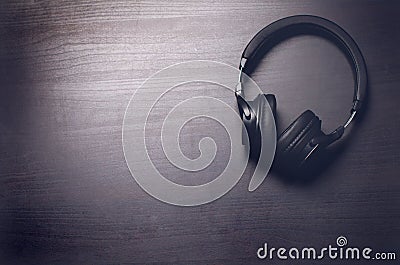 Headphones on a dark background. Music accessories. Bluetooth headphones without cable. Stock Photo