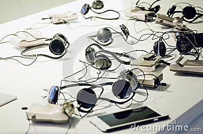 Headphones, headset, phones are on the table Stock Photo