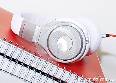 Headphones and Spiral notebook on the desktop Stock Photo