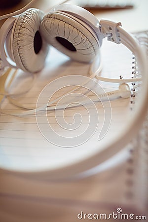 Headphones on spiral notebook Stock Photo