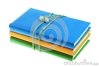 Headphones and stack of multicolored books on a white background Stock Photo