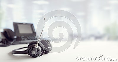 Headset headphones telephone on desk in call center Stock Photo